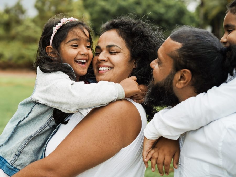 Happy indian family having fun outdoor - Hindu parents laughing