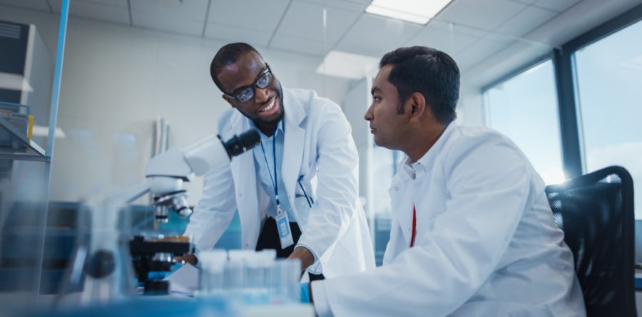 Modern Medical Research Laboratory: Two Smiling Male Scientists / Doctors