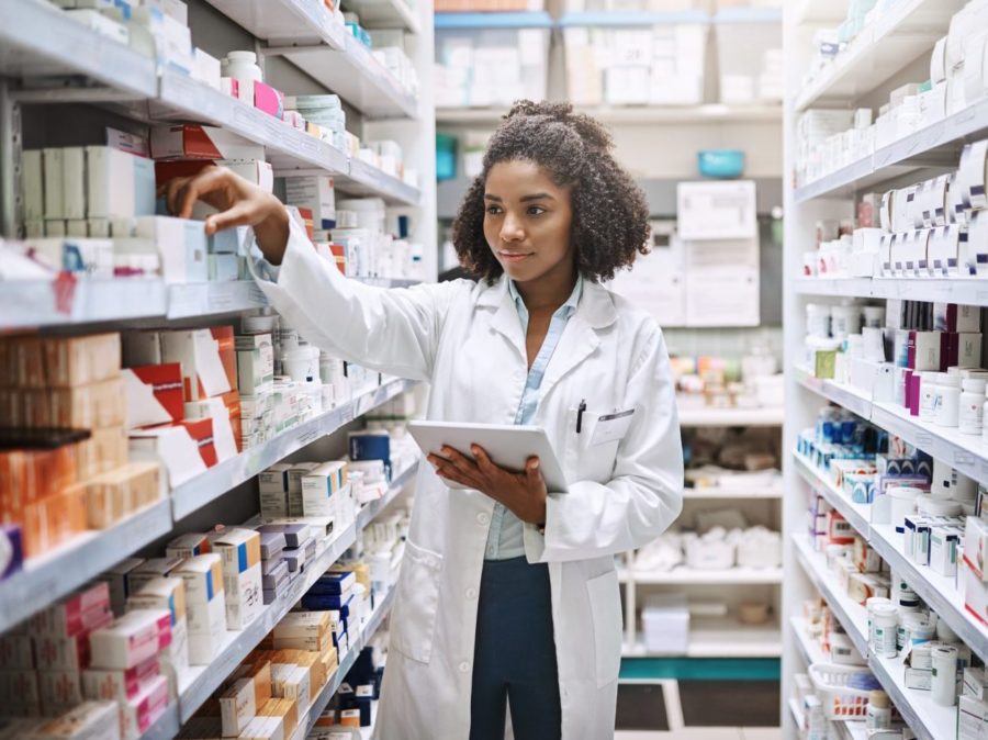 Never Fear, Your Pharmacist Is Here. Cropped Shot Of An Attractive Young Female Pharmacist Working In A Pharmacy.