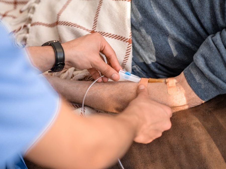 Healthcare Worker Preparing A Male Person For A Medical Procedure