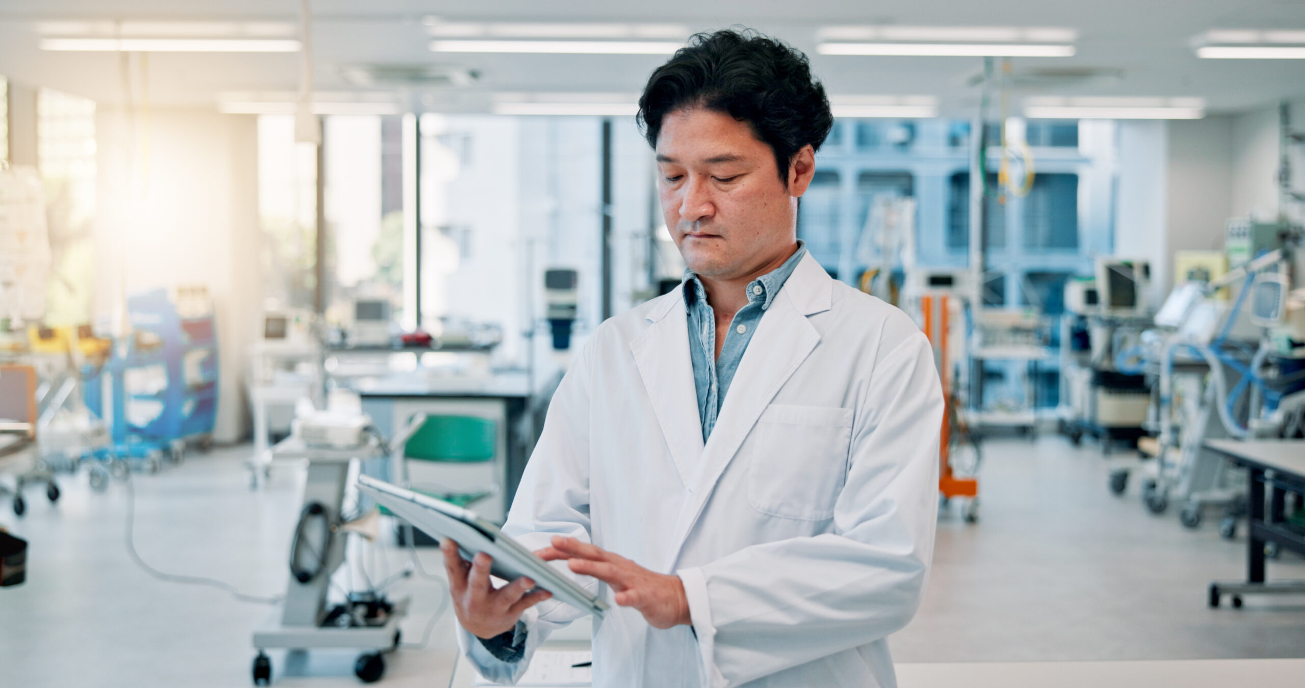 Man, scientist and serious on tablet at laboratory for medical research, investigation or results on vaccine tests in Japan. Male person, healthcare professional and innovation for drug trial results